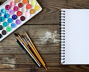 Bright watercolor paints and art supplies for creative projects and artistic expression.