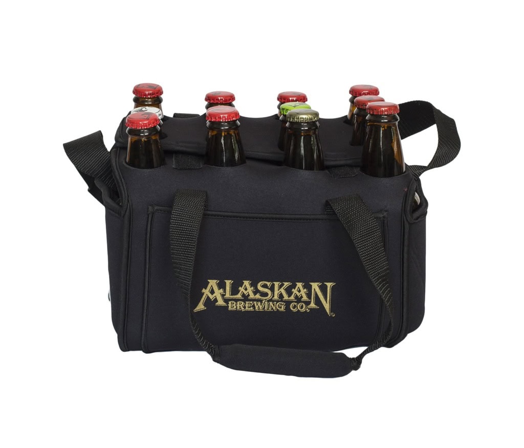 Black neoprene bottle carrier with a gold Alaskan Brewing Co. logo and shoulder strap, holding capped bottles.