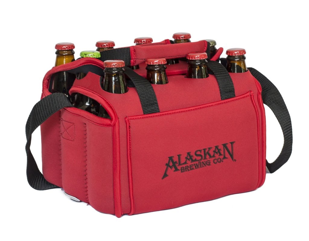 Red neoprene twelve-bottle carrier with black straps and an Alaskan Brewing Co. logo, filled with bottles.