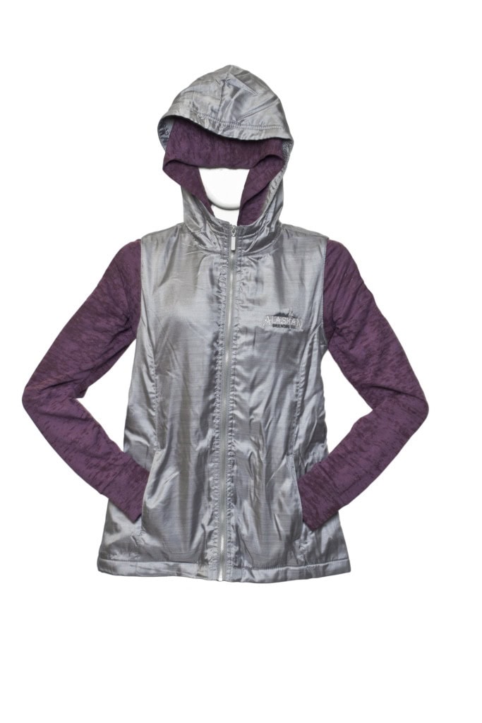 Silver hooded zip vest with an embroidered Alaskan logo over a purple long-sleeve top, on a mannequin.