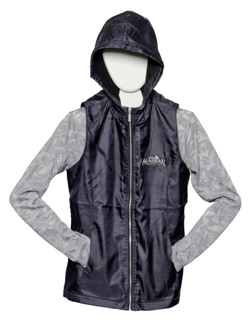Black hooded zip vest with an embroidered Alaskan logo over a gray patterned long-sleeve top, on a mannequin.