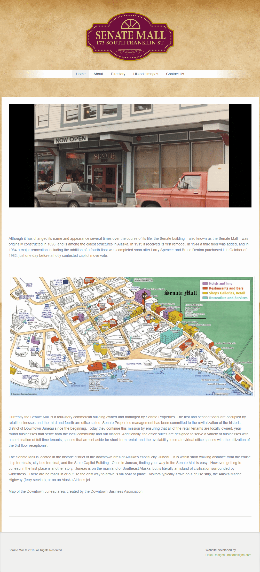 Historic Alaska shopping center with vintage storefront and classic vehicles.