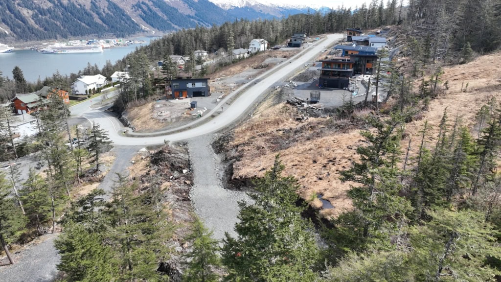 Hillside lots next to newly built homes above the water