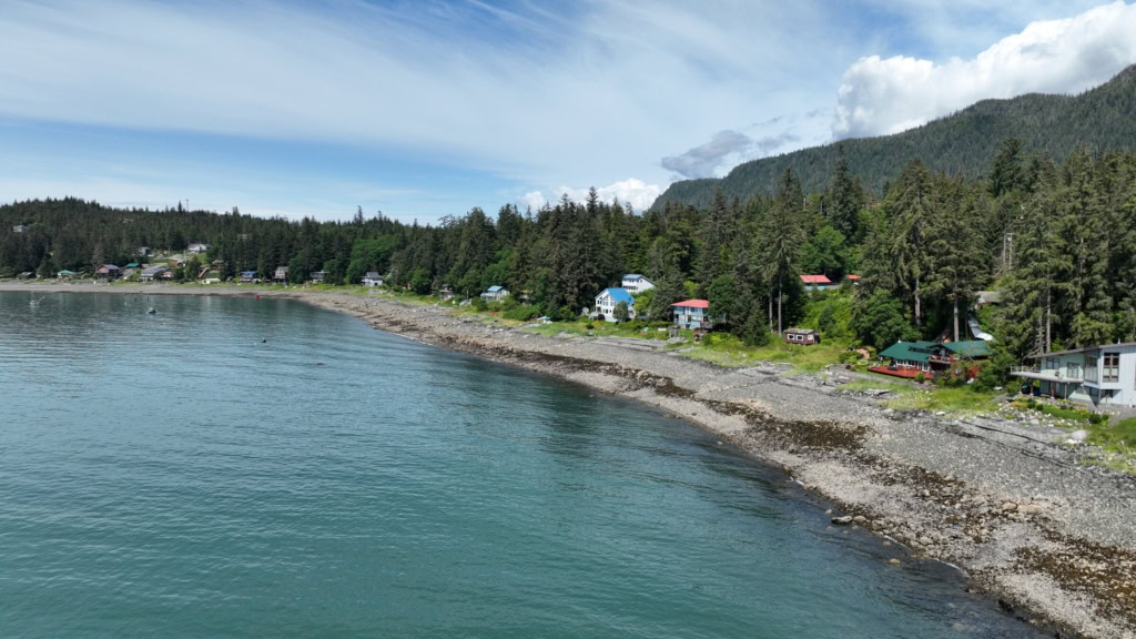 Calm water in a cove with houses along the shore