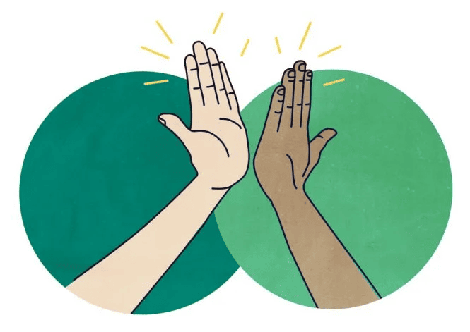 Diverse hands giving a high-five symbolizing teamwork and unity.