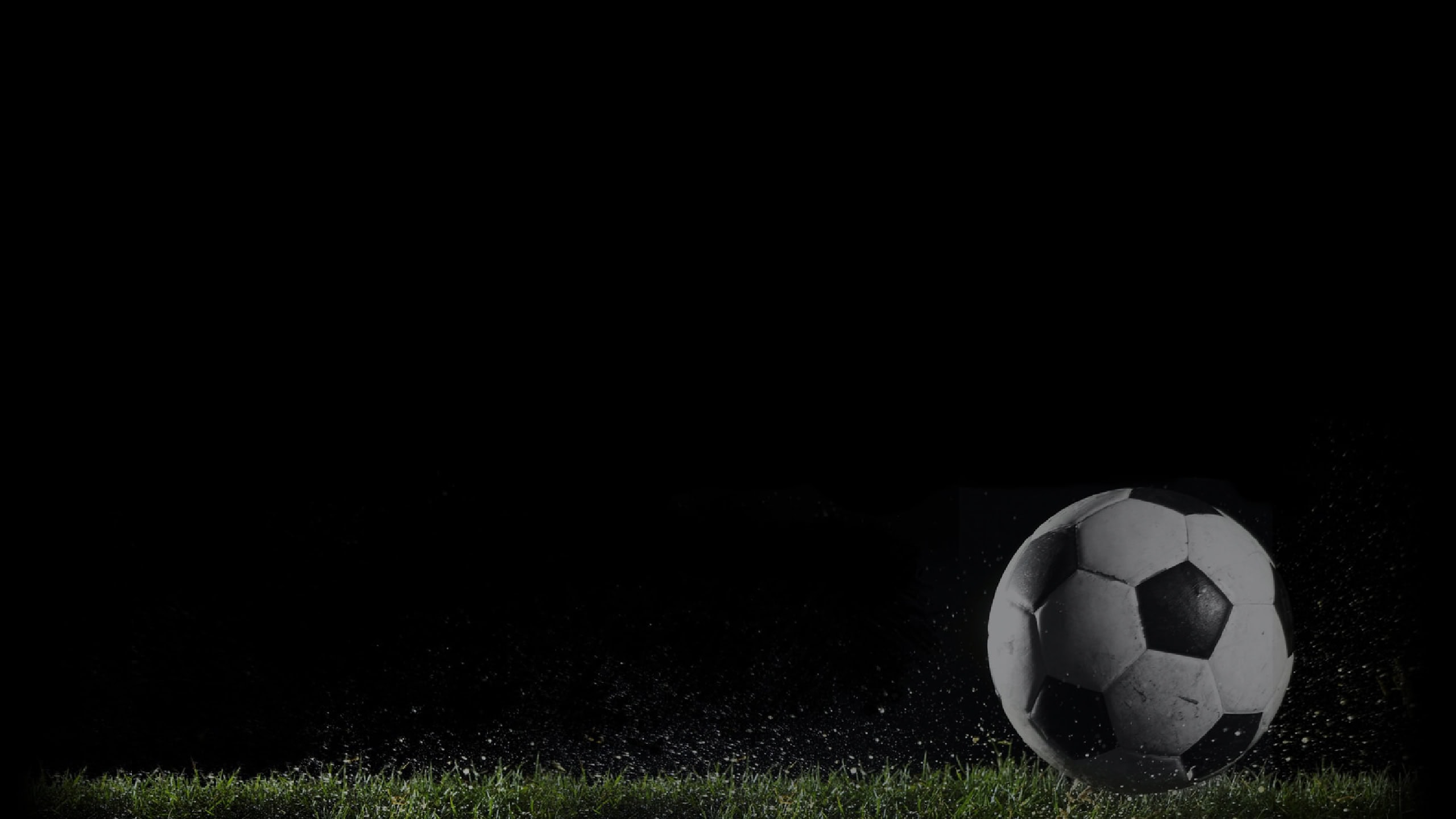 Soccer ball on lush green grass during night, perfect for sports, football, or soccer enthusiasts.