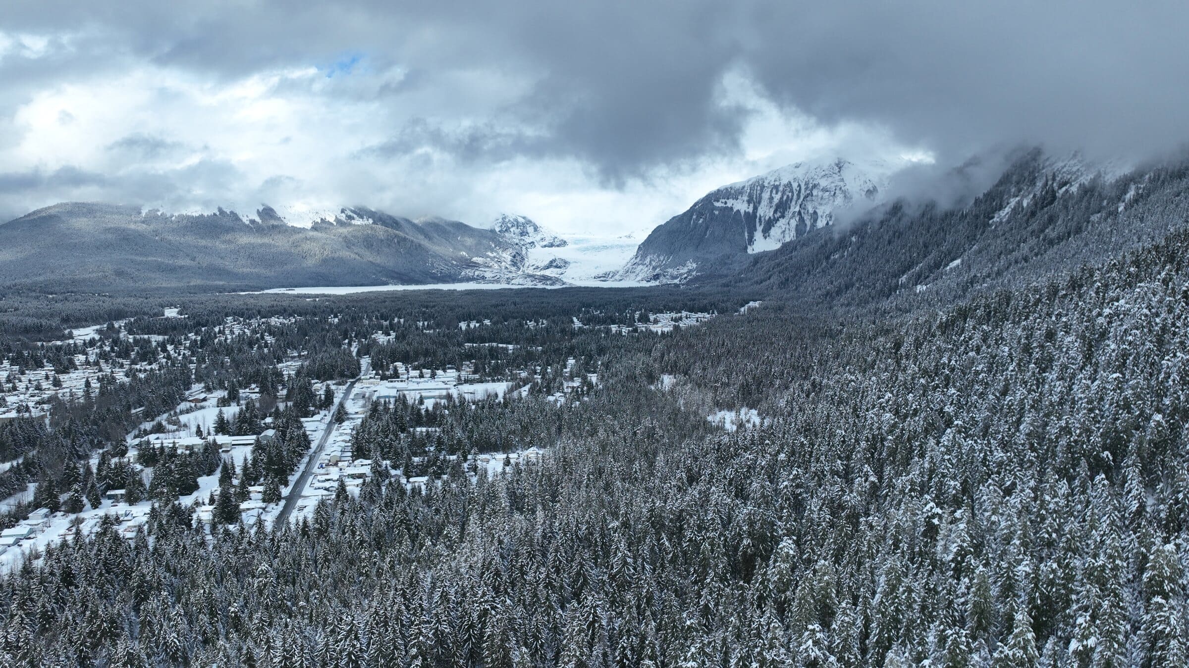 Late snow rarely lasts here, so we flew the same hillside three mornings running and caught the storm breaking over the glacier.