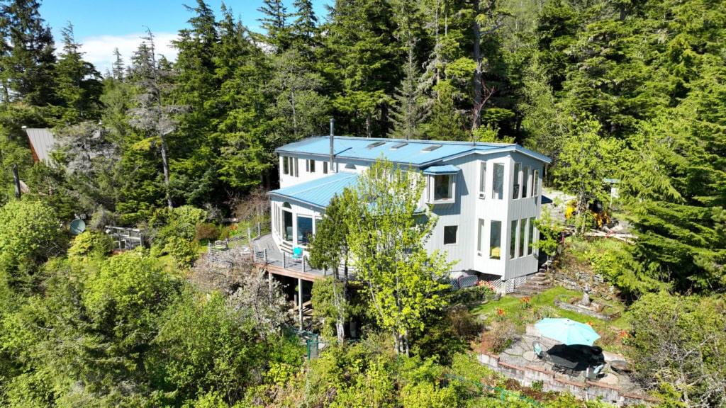 A house with a sunroom on a wooded bluff