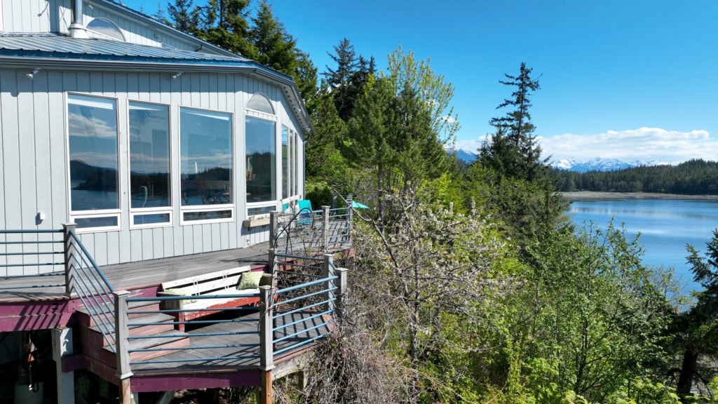 Glass sunroom on a deck above the water