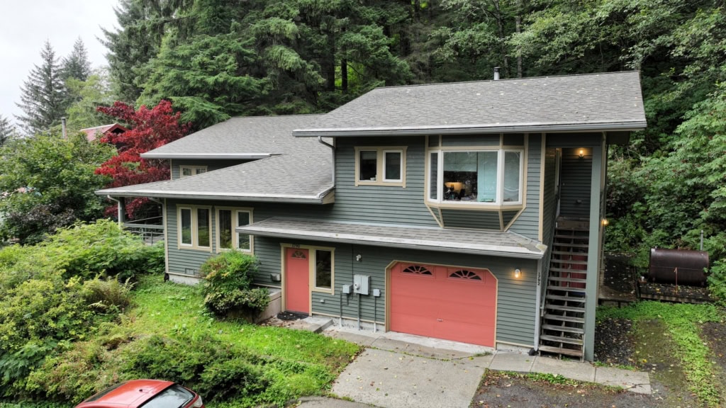 House exterior with a red garage door and exterior stairs