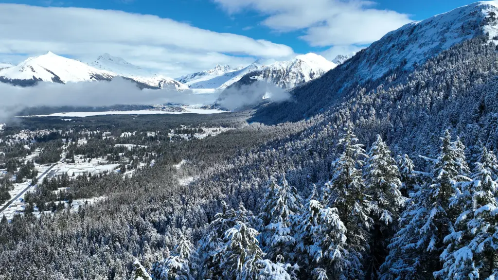 Snowy mountains with low cloud lying over the valley beneath them